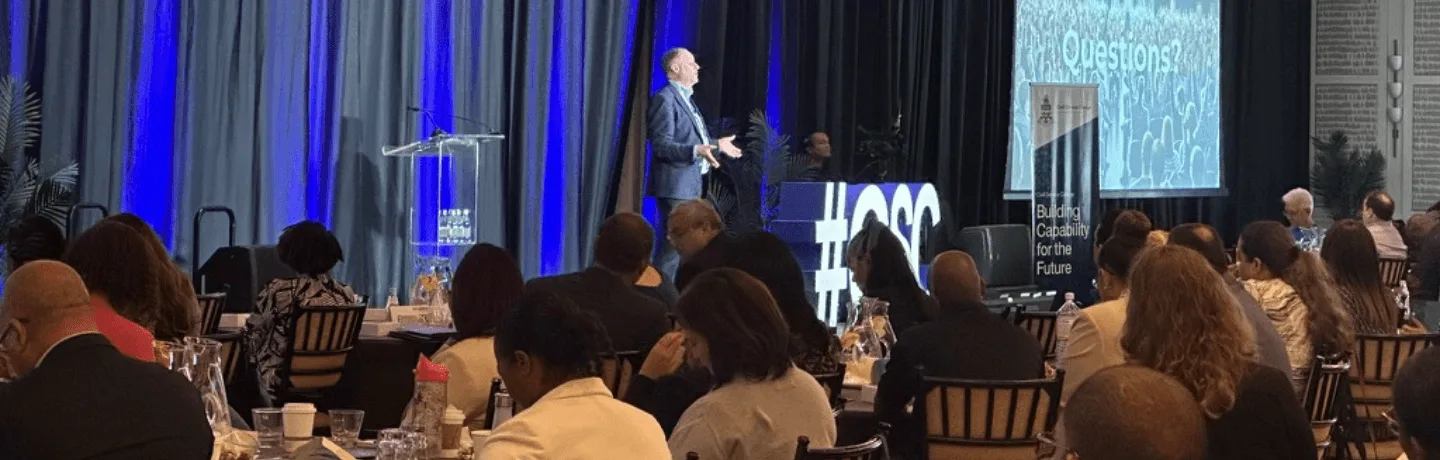 AI Expert Andrew on stage in the Cayman Islands for the Cayman Islands Government on how the public sector can leverage AI