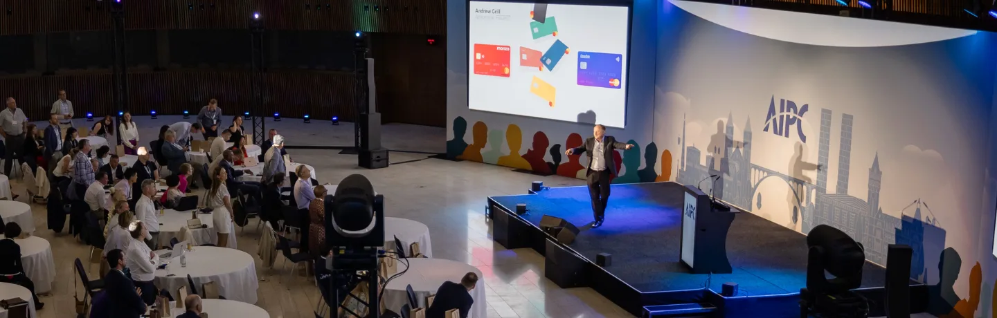 AI Expert Andrew Grill on stage in Luxembourg speaking on how event organisers can harness the power of AI