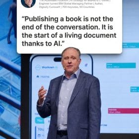 book-ai-post-image » The Actionable Futurist® Andrew Grill - Trusted Board-level Advisor & International Keynote Speaker Male presenter in a blue blazer on stage, with a speech bubble showing Andrew Grill's quote about publishing a book starting a living document thanks to AI; a large smartphone graphic and slides visible in the background.